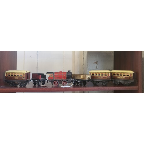 114 - Hornby Series 0 gauge clockwork red 0-4-0 locomotive and tender 3435, NE wagon and two 'Marjorie' an... 