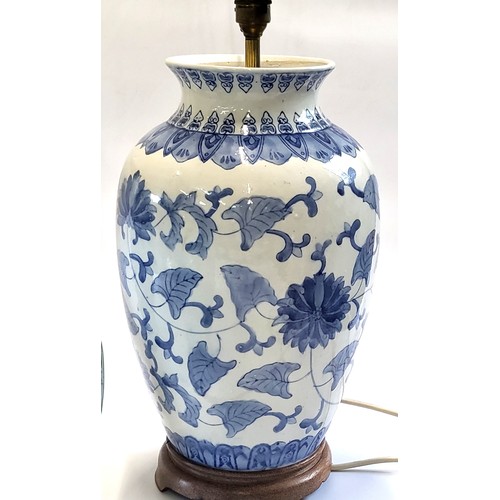 38 - Two blue and white lamps in Oriental style and a turquoise lamp with flooded village scene Heights b... 