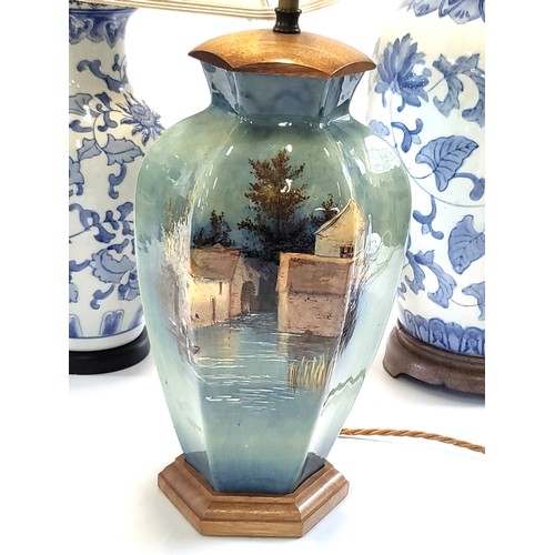 38 - Two blue and white lamps in Oriental style and a turquoise lamp with flooded village scene Heights b... 