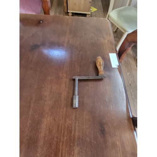 14 - A mahogany dining table with a spare leaf H.72cm W.127cm - 180cm D.105cm and six balloon back dining... 