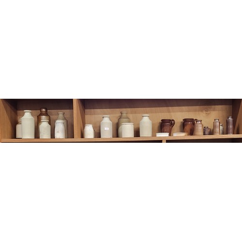 218 - Twenty-five items of stoneware bottles and jars. Largest 28cm. (25)