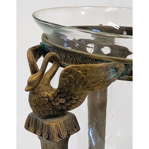 180A - A decorative Hurricane Lamp set on a marble base on a three legged brass support topped with swan fi... 