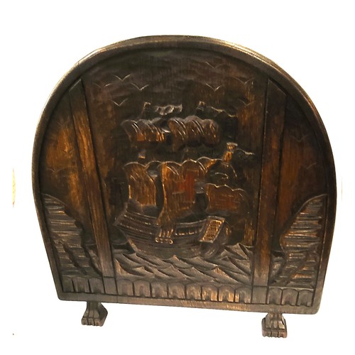 26 - An oak fire screen depicting a sailing vessel. 68 x 68cm.