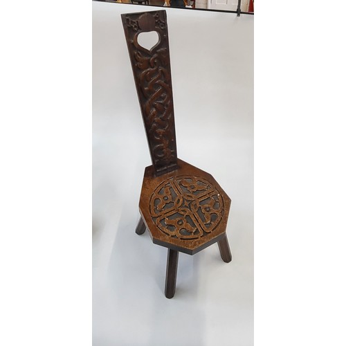 27 - An oak Welsh spinning chair carved in 1898. 83 x 29 x 36cm.