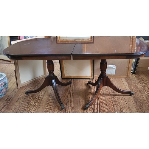 50 - A twin pedestal extending dining table in a mahogany finish.
165 x 91 or 256cm when extended. 
Top h... 