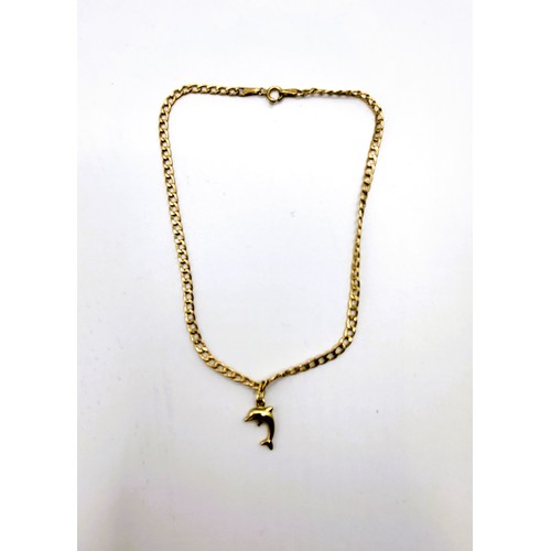 365 - A 9ct yellow gold  curb link chain anklet with a bolt ring clasp and a dolphin charm. 1.1gms.