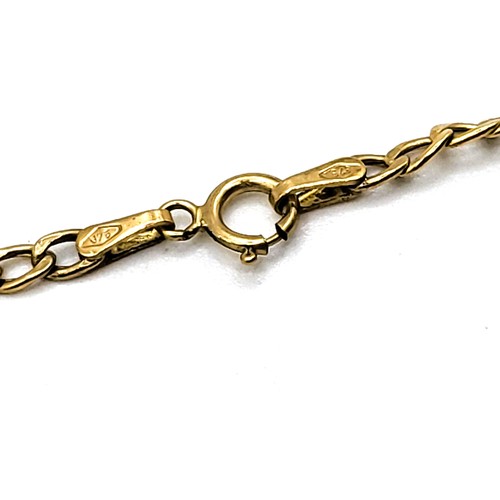 365 - A 9ct yellow gold  curb link chain anklet with a bolt ring clasp and a dolphin charm. 1.1gms.