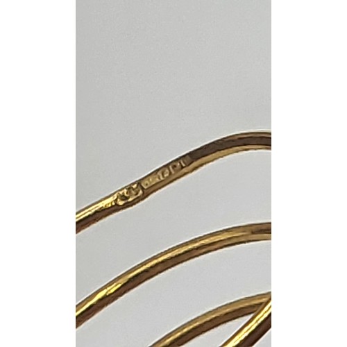 384 - A 22ct yellow gold spiral ring with paste and faux pearls. Size variable O-P. 7.4gms, and a pair of ... 