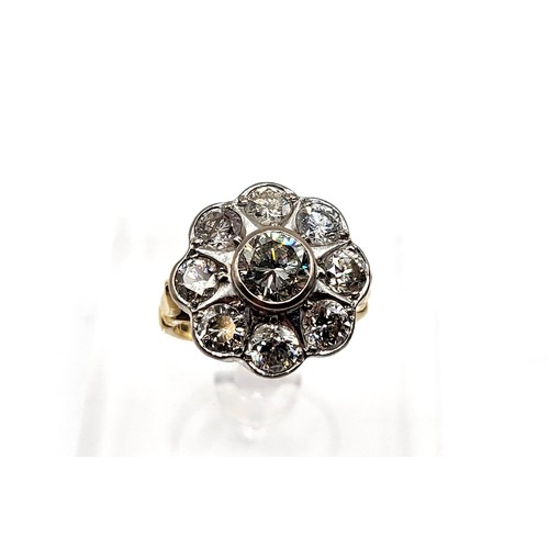 390 - An 18ct yellow gold nine stone diamond daisy ring. Central stone approx. 1.0ct approx. 3.5+tcw. 8.7g... 