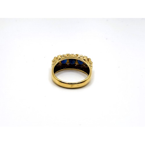 392 - An 18ct yellow gold Victorian style setting sapphire and diamond set ring. With five graduated oval ... 