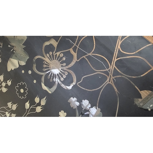 44 - An etched floral design glass black table with a pair of A-frame legs.