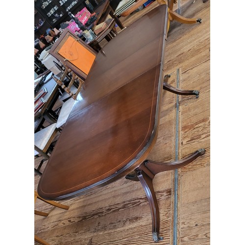 50 - A twin pedestal extending dining table in a mahogany finish.
165 x 91 or 256cm when extended. 
Top h... 