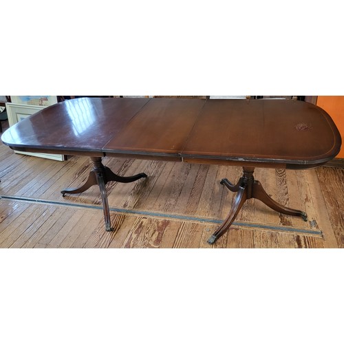 50 - A twin pedestal extending dining table in a mahogany finish.
165 x 91 or 256cm when extended. 
Top h... 