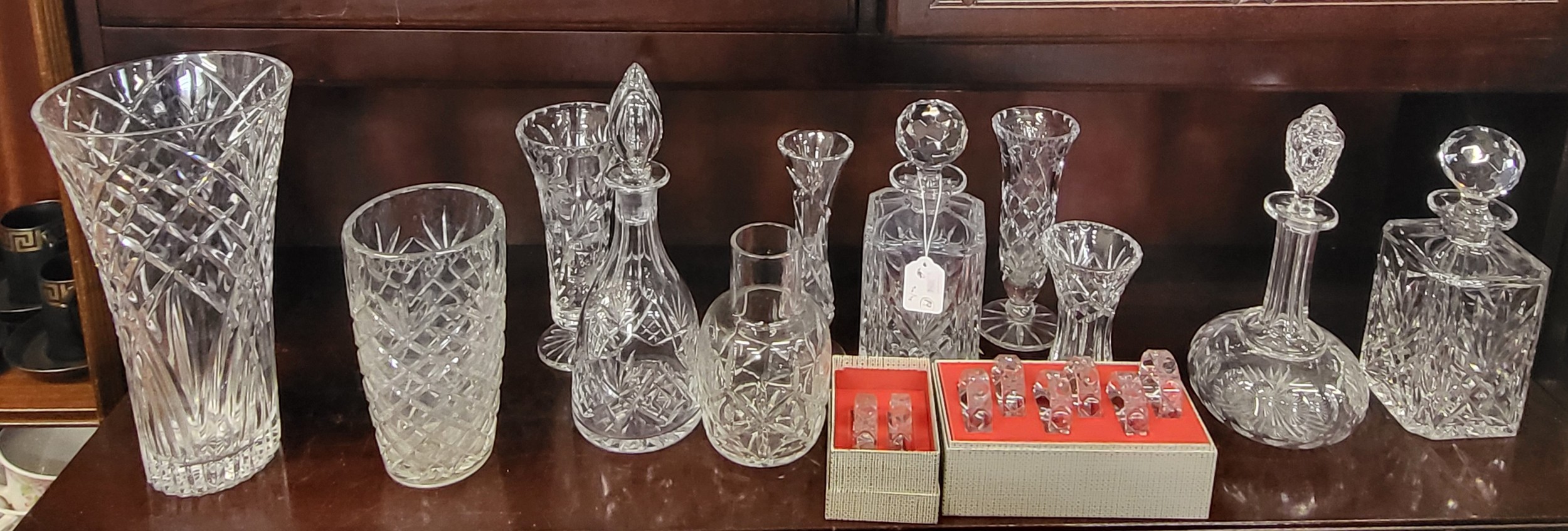 Two boxed sets of cut glass napkin rings, pair of square decanters ...