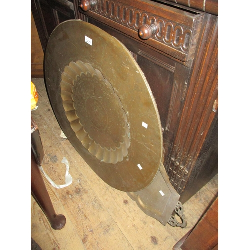 2471 - Two Benares brass tables on wooden stands, together with a Benares brass two handled tray