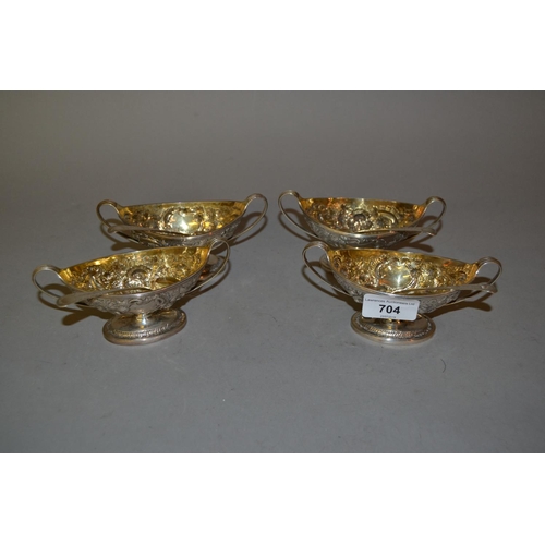 704 - Set of four George III London silver two handled pedestal salts having embossed floral decoration, m... 