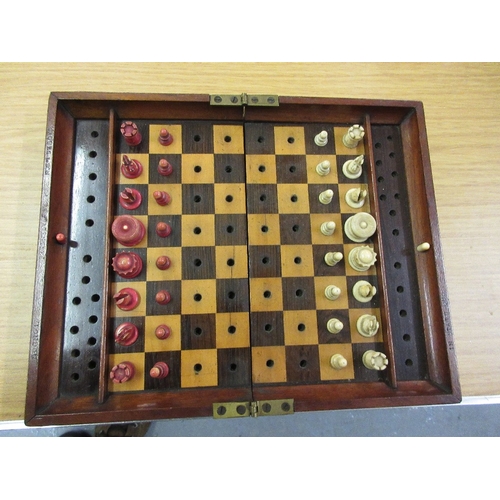 106 - Early 20th Century mahogany cased travelling chess set with natural and red stained bone pieces by J... 