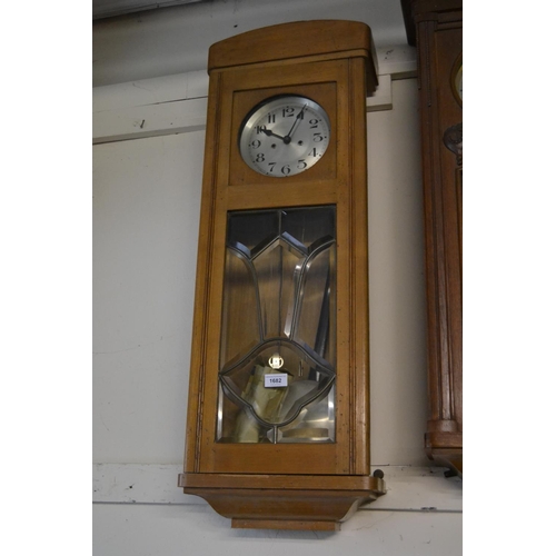 1682 - Early 20th Century oak Vienna style wall clock, the silvered dial with Arabic numerals above a bevel... 