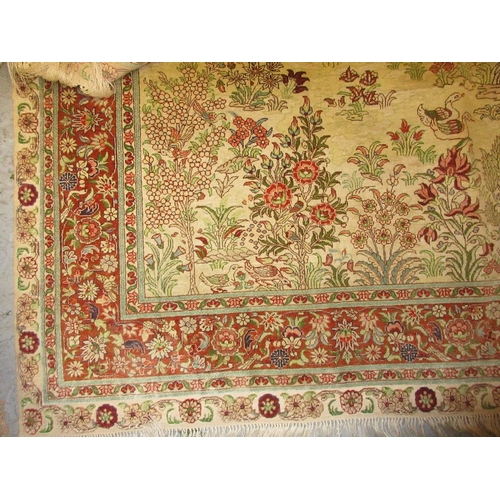 18 - Turkish silk rug decorated with birds in a landscape, approximately 60ins x 36ins