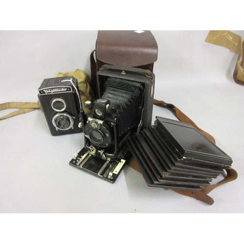 401 - Voigtlander Brilliant model camera together with a plate camera with plates, in leather case