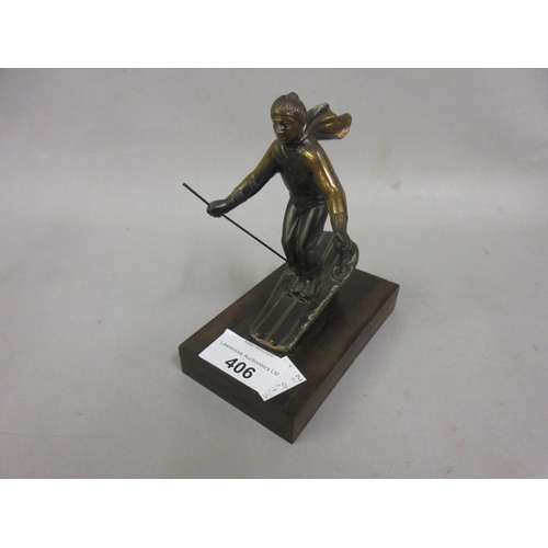 406 - Brown patinated metal figure of a skiier mounted on a hardwood base