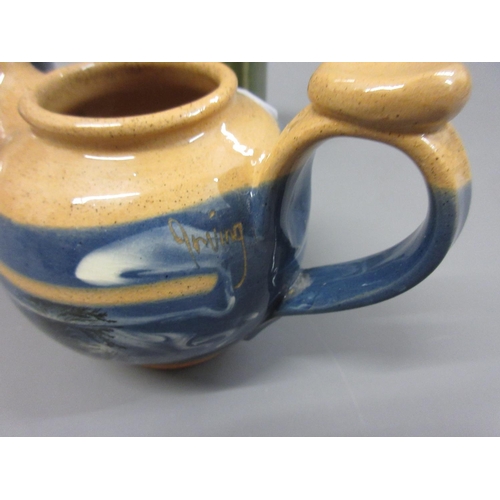 540 - Roger Irving for Boscastle pottery, a small cream pot decorated with a landscape on a mottled blue g... 