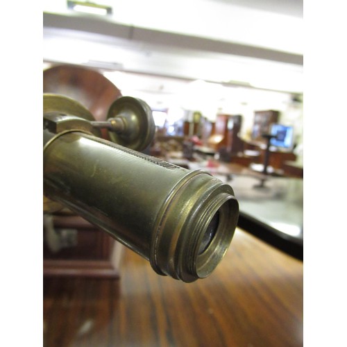 289 - Early 20th Century brass sighting scope mounted on an iron tripod stand