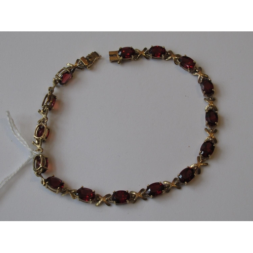 1038 - 9ct Yellow gold garnet set bracelet