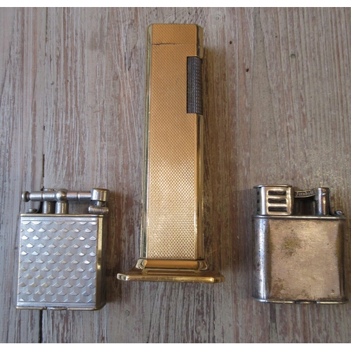 1079 - Dunhill gold plated tallboy table cigarette lighter, together with two other Dunhill cigarette light... 