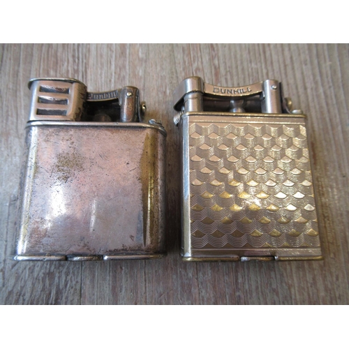 1079 - Dunhill gold plated tallboy table cigarette lighter, together with two other Dunhill cigarette light... 