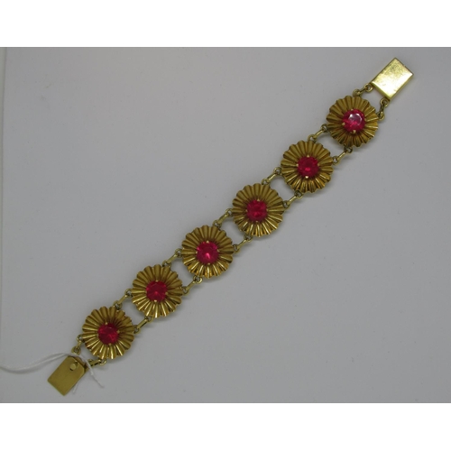 1081 - Mid 20th Century yellow metal and synthetic ruby bracelet of repeating linked flowerhead design