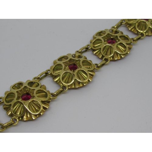 1081 - Mid 20th Century yellow metal and synthetic ruby bracelet of repeating linked flowerhead design