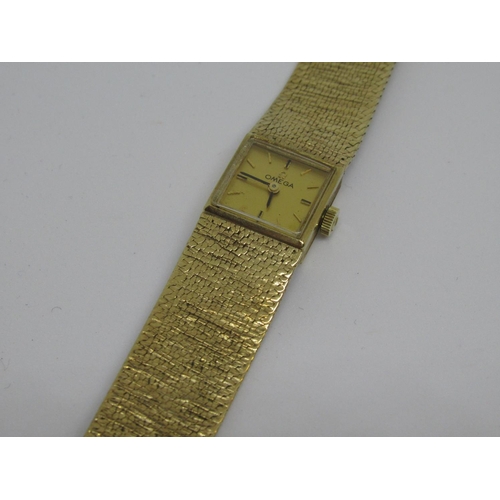 1088 - Ladies Omega 9ct yellow gold wristwatch with integral bracelet strap