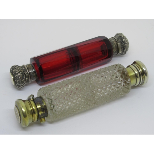 1101 - Victorian cranberry glass double ended scent bottle with embossed silver covers, together with a cut... 