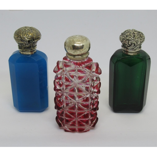 1102 - Group of three Victorian coloured glass scent bottles with silver covers