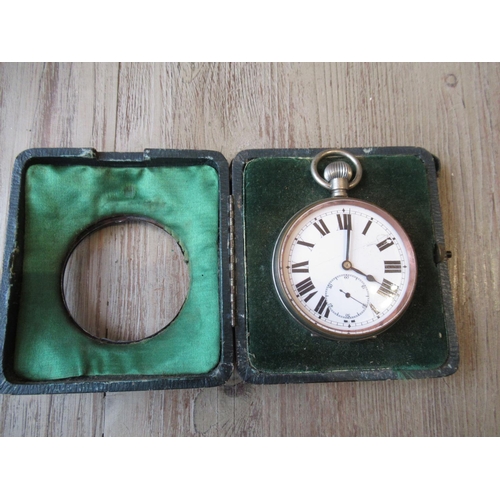 1134 - Silver mounted leather travelling pocket watch case containing a large nickel plated pocket watch