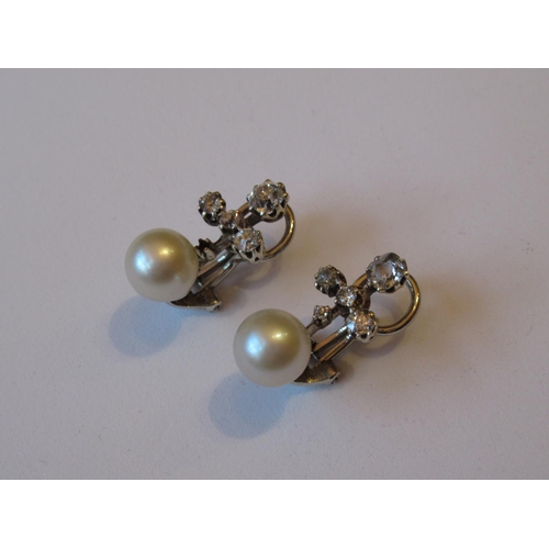 1135 - Pair of white gold ear clips, each set with a cultured pearl and five rose cut diamonds (one diamond... 