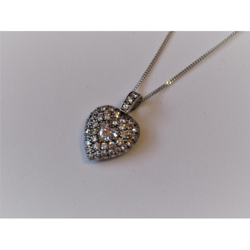 1149 - Edwardian diamond encrusted heart shaped pendant suspended from a later 9ct white gold chain, the pe... 