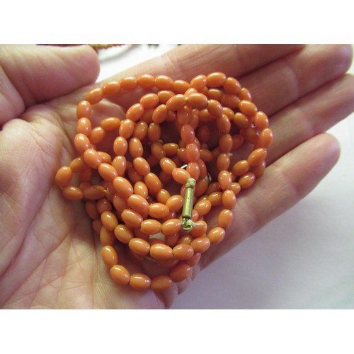 1131 - Coral expanding bangle with carved dragon's head finial, together with a quantity of other coral and... 