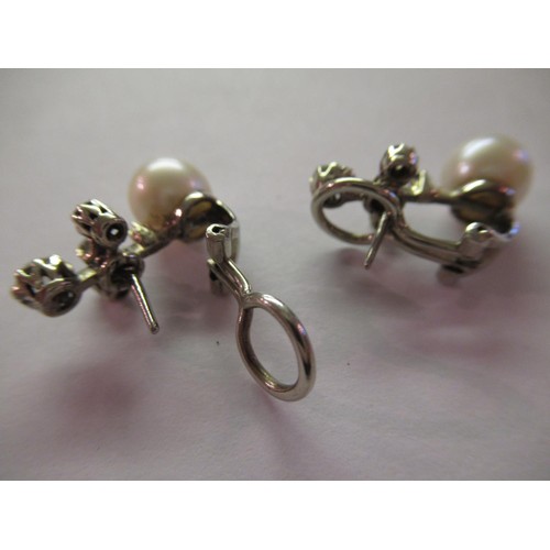 1135 - Pair of white gold ear clips, each set with a cultured pearl and five rose cut diamonds (one diamond... 