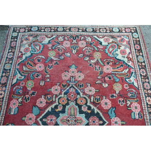 11 - Saruq rug with centre medallion and floral design on rose ground with borders, 6ft 8ins x 4ft 6ins a... 