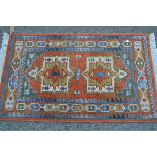 12 - Small machine woven Persian design rug with twin medallion design, 3ft 8ins x 2ft 4ins approximately... 