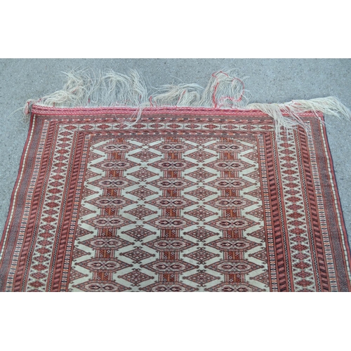 13 - Good quality mid to late 20th Century Tekke rug with multiple gol design on an ivory ground with mul... 