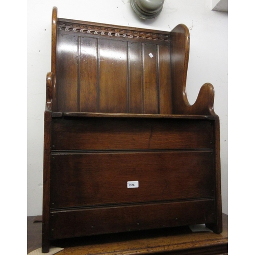 1376 - Good quality reproduction oak miniature settle, the boarded wing back above a box seat with hinged l... 