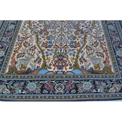 31 - Modern Qum style rug with a tree of life design on an ivory ground with floral borders, 8ft 6ins x 5... 