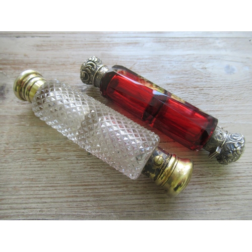 590 - Victorian cranberry glass double ended scent bottle with embossed silver covers, together with a cut... 