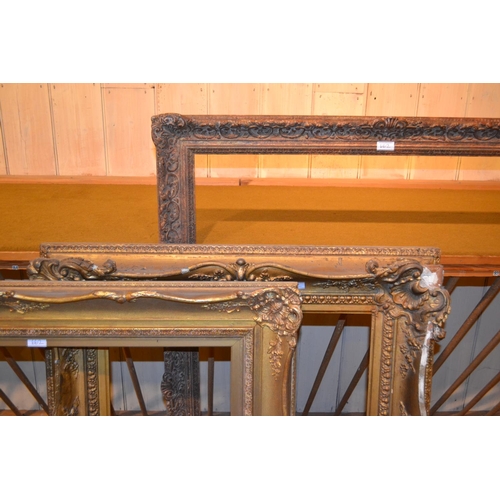 662 - Large rectangular swept gilt picture frame, 45ins x 33.5ins rebate, together with three other simila... 