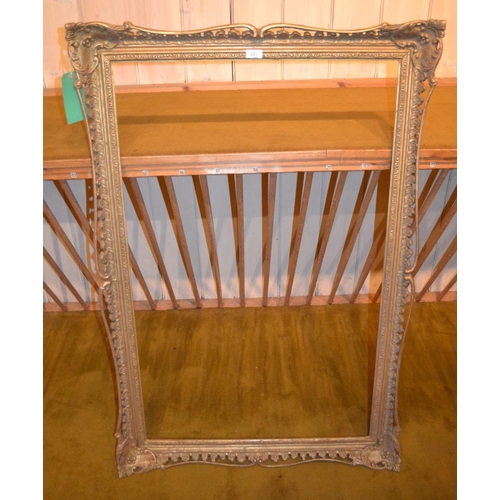 663 - Swept gilt picture frame, 43.75ins x 27.75ins rebate together with four other various frames