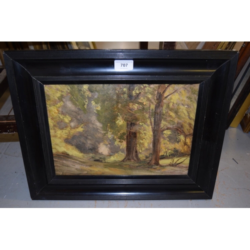 707 - An ebonised framed oil on panel, sunlit woodland path, bearing label verso 'Norbury Woods, Frank Spe... 