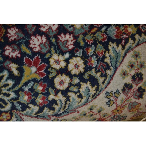 32 - Machine woven Persian design carpet with a medallion and floral design on ivory ground, 10ft x 7ft a... 